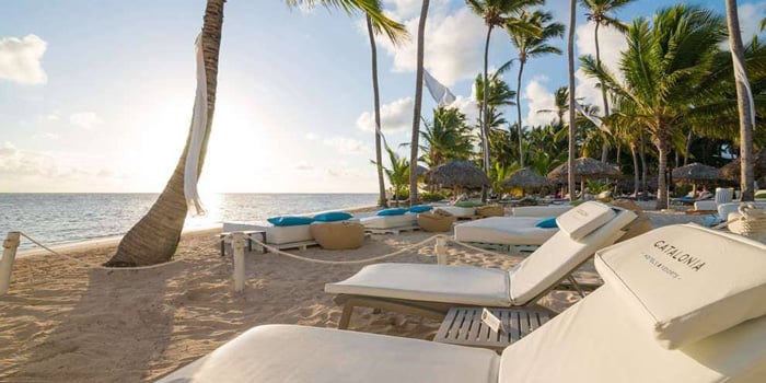 White beach chairs on sand